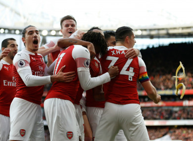 A banana skin is thrown onto the pitch as Arsenal players celebrate after their opening goal against Tottenham.