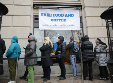 People wait in line at Chef Jose Andres' World Central Kitchen for free meals to workers affected by the government shutdown in Washington