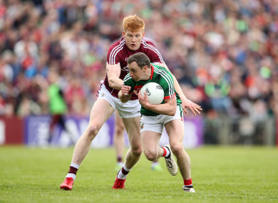 Mayo's Keith Higgins under pressure from Peter Cooke of Galway during last year's Connacht championship.