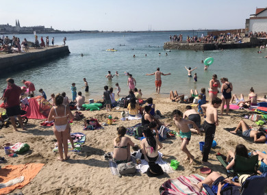 Crowds of people enjoying the sunny weather on the beach in Sandycove, Dublin in July 2018