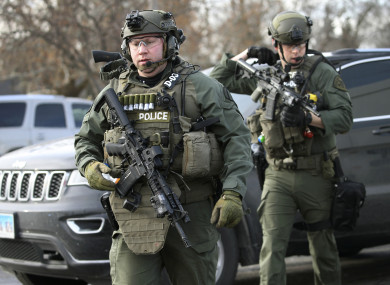 Police officers armed with rifles at the scene