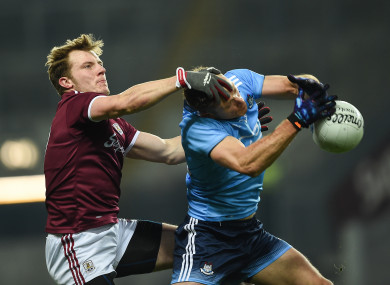 Gearoid Armstrong competes for a ball with Paul Flynn.