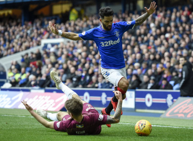 St Johnstone's Jason Kerr and Rangers Daniel Candeias in action.