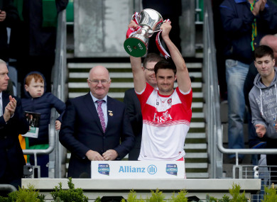 Christopher McKaigue lifts the trophy.