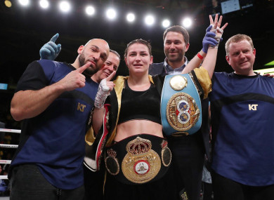 Katie Taylor celebrates a piece of Irish boxing history with her team.