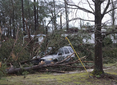 A vehicle is caught under trees in Beauregard, Alabama following a tornado on Sunday night.