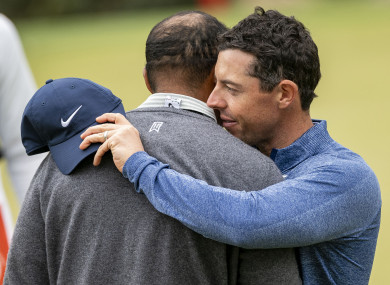 Tiger Woods embraces Rory McIlroy (right) on the 17th green.