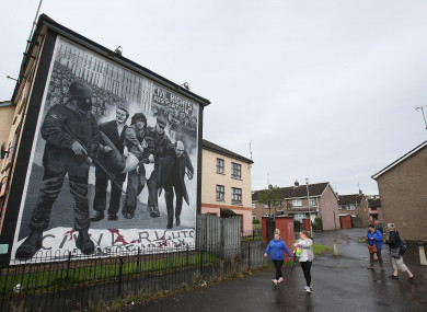 A mural in the Bogside area of Derry depicting Dr Edward Daly as he led injured civil rights protestor Jackie Duddy away from gunfire on Bloody Sunday.