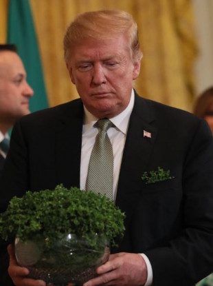US President Donald Trump with a bowl of shamrock presented by Taoiseach Leo Varadkar at the White House on Thursday.