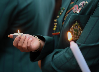 Students light candles to mourn victims during a mourning ceremony near the attack site in Christchurch.