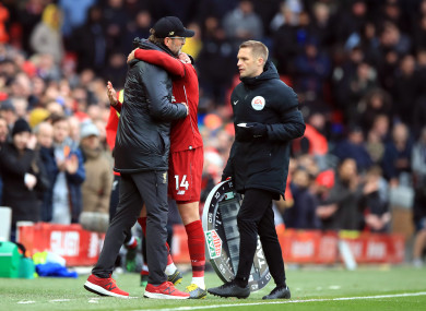 Klopp embraces Henderson after Liverpool's defeat of Chelsea on Sunday.