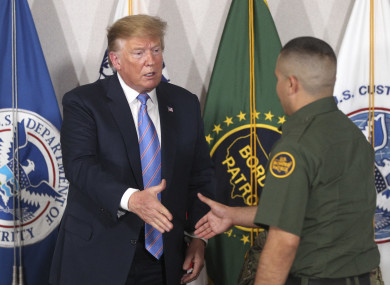 US President Donald Trump shakes hands with a Border Patrol agent last week.