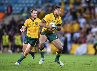 Israel Folau in possession during Australia's game against Argentina last September, as Bernard Foley looks on.