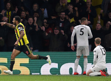 Fulham players watch on as Troy Deeney celebrates a goal for Watford.