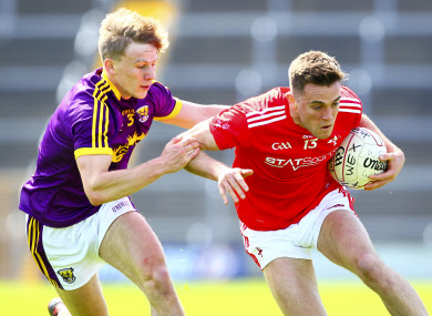 Louth's Andy McDonnell is tackled by Wexford's Martin O'Connor.