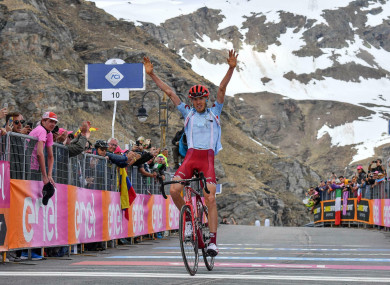 Zakarin celebrates while crossing the finish line to win the 13th stage.
