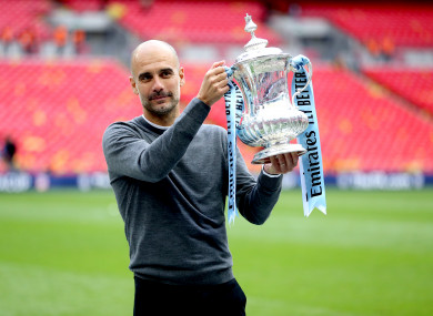 Guardiola holding the FA Cup at Wembley.