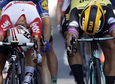 Australia's Caleb Ewan, left, and Netherlands' Dylan Groenewegen cross the finish line during the 11th stage of the Tour de France.