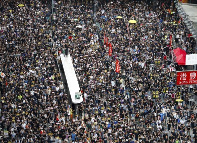 Protesters take part in a march in Hong Kong today.