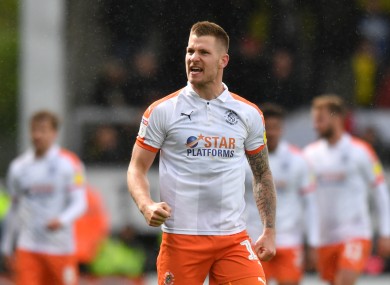 James Collins celebrates after scoring for Luton Town against Burton Albion last April.