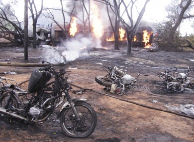 Destroyed motorbikes and debris litter the scene in Morogoro