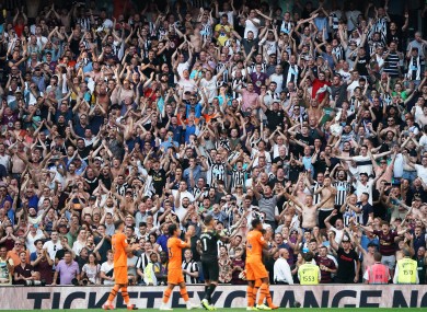Newcastle fans celebrate with the players at full-time.