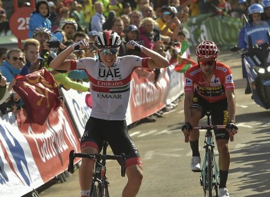 Tadej Pogacar of Slovenia, left, celebrates after winning the 13th stage.
