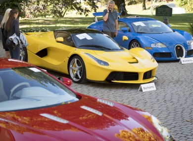 People looking at a Ferrari LaFerrari at the auction