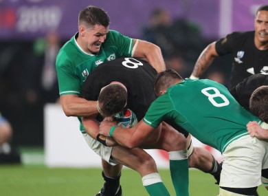 All Blacks player Kieran Read is tackled by Ireland’s Jonathan Sexton.