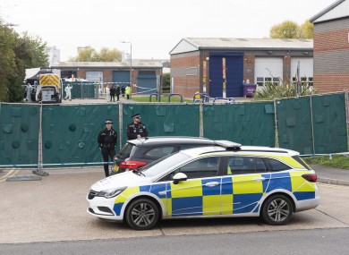 Police officers guard the Waterglade Industrial Park where 39 bodies were found in a lorry container in Grass, Essex.