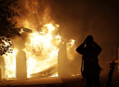 A firefighter prepares to fight a wildfire as it overtakes a home Thursday, Oct. 24, 2019, in Santa Clarita, California.