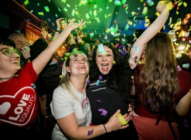 Martha Brown with her partner Louise McCullough and equal marriage supporters at Maverick Bar, Belfast, celebrate the change to abortion and same sex marriage laws.