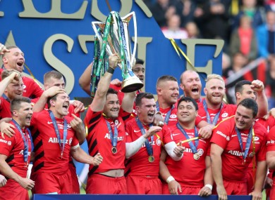 Saracens' Brad Barritt lifts the Heineken Champions Cup after their win over Leinster.
