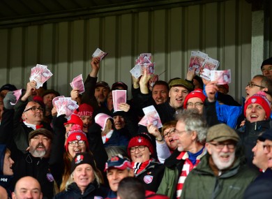 Gloucester fans waving fake money.