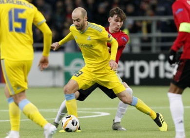 Astana's Ivan Mayewski, centre left, and Manchester United's James Garner challenge for the ball.