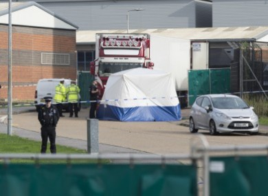 Police officers work at the scene where 39 bodies were found in a shipping container at Waterglade Industrial Park in Essex.