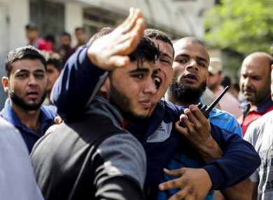 Palestinian men mourn outside the al-Shifa hospital in Gaza city.