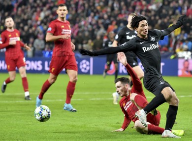 Takumi Minamino tackled by Andy Roberston in last week's Champions League game.