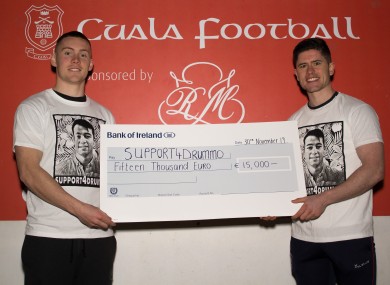 Con O'Callaghan and Conor Mullally with the cheque.