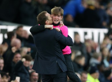 Everton caretaker manager Duncan Ferguson celebrates with a ball boy.