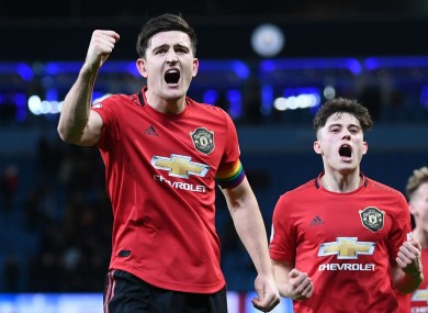 Harry Maguire leads Man Utd's celebrations after their derby victory.