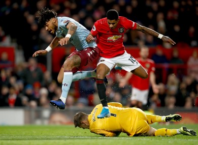 Aston Villa goalkeeper Tom Heaton and Aston Villa's Tyrone Mings (left) battle for the ball with Manchester United's Marcus Rashford.