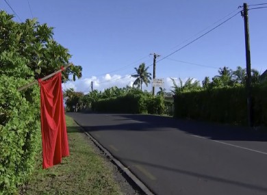 A red flags hangs outside the home of residents who have not been vaccinated in Apia, Samoa, today