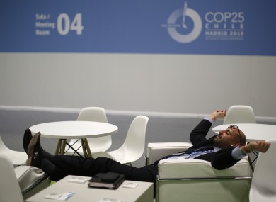 A visitor rests at the COP25 climate talks congress in Madrid