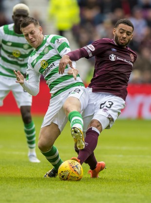 Celtic's Callum McGregor tangles with Jake Mulraney of Hearts.