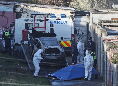 A burnt out car which contained human remains, believed to be linked to the disappearance of a 17-year-old boy from Co Louth, is removed from the scene on Trinity Terrace in the Drumcondra area of Dublin.