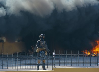 An Iraqi soldier stands guard in front of the US embassy.