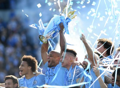 Manchester City celebrate with the Premier League trophy.