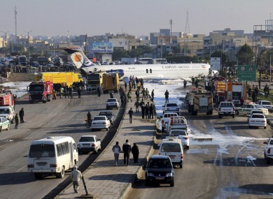 A passenger plane sits on a road outside Mahshahr airport in Iran