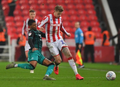 Stoke City's James McClean is tackled by Rhian Brewster of Swansea.